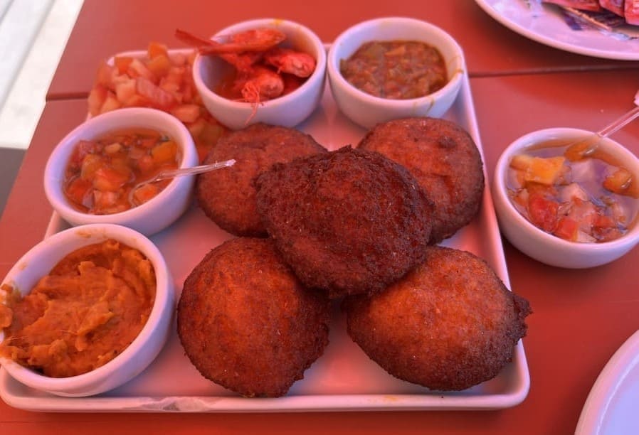 Traditional acarajé, a typical Bahian street food, served with shrimp and spicy fillings in Salvador, Brazil