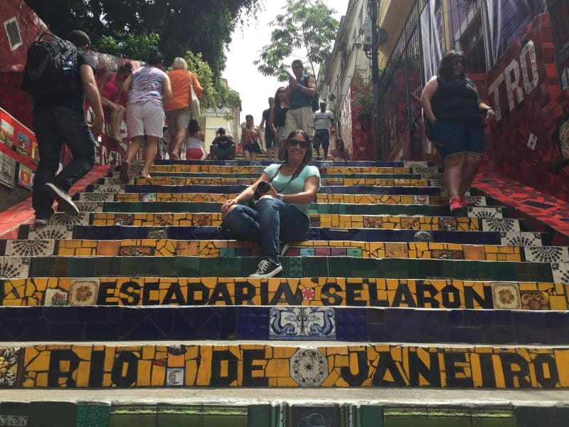 Visitors sitting and walking on the colorful Selarón Steps in Rio de Janeiro.